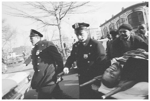 Malcolm X, who fought against the oppression of African Americans, on a stretcher after being shot and killed by assassins on February 21, 1965. CORBIS