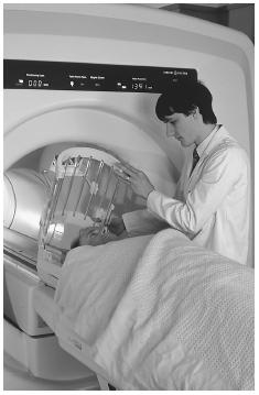 A radiographer prepares a patient for an MRI scan, a technology that revolutionized medical imaging by using magnets and magnetic fields. The results of a scan can save a patient's life by providing useful information in detecting serious health conditions. PHOTO RESEARCHERS